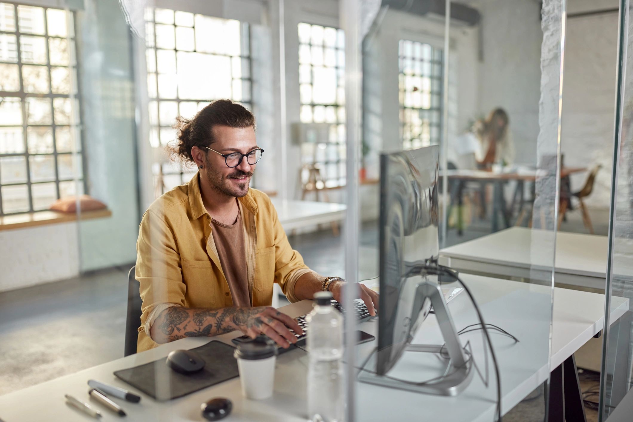 Designer working at a computer representing creative and digital support