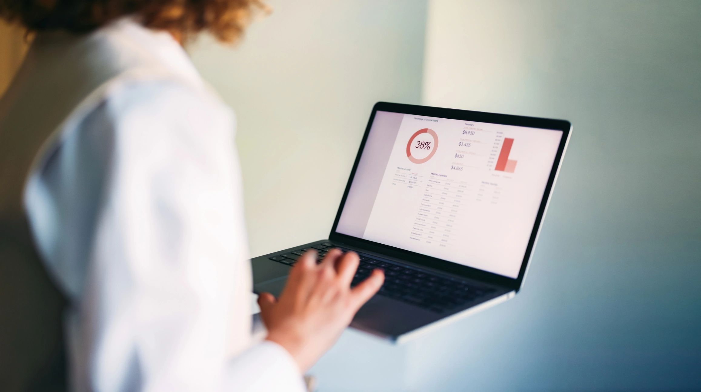 Person analysing a laptop dashboard with charts and performance metrics